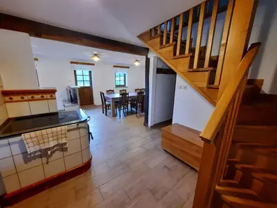 a kitchen and dining room with a staircase in a house at Holiday home in Semic Kranjska Krain 42896 in Semič