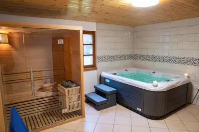 a large bathroom with a tub and a shower at Country House & Spa in Mislinja