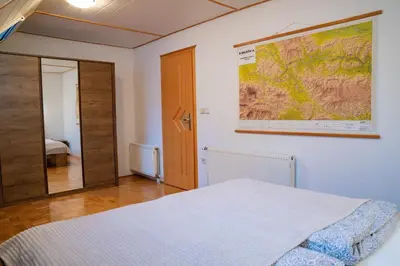 a bedroom with a bed and a large map on the wall at Country House & Spa in Mislinja