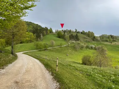 a dirt road with a yield sign on a hill at Mountain View Cottage in Kamnik