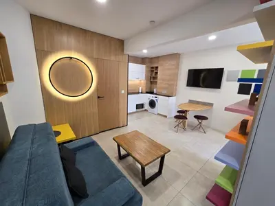 a living room with a couch and a table at Apartment ARSO in Velenje