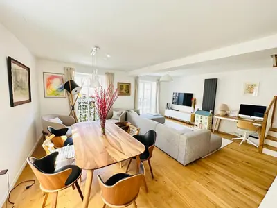 a living room with a table and a couch at Top view residence in central Ljubljana in Ljubljana