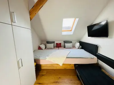 a small bedroom with a bed in a attic at Top view residence in central Ljubljana in Ljubljana