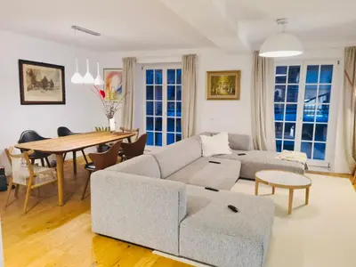 a living room with a couch and a table at Top view residence in central Ljubljana in Ljubljana