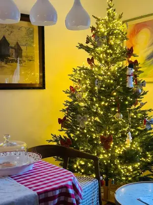 a christmas tree in a dining room with a table at Top view residence in central Ljubljana in Ljubljana