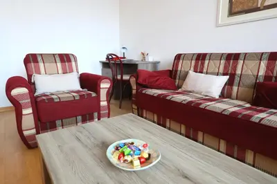 a living room with two couches and a table with a plate at Thomas apartment 028 in Ljubljana