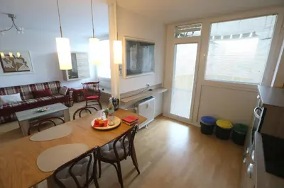 a kitchen and living room with a table and chairs at Thomas apartment 028 in Ljubljana