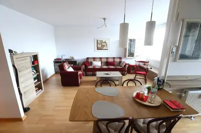 a living room with a table and a couch at Thomas apartment 028 in Ljubljana