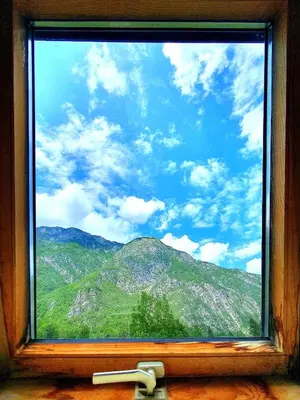 a window with a view of a mountain view at Bohinj Star Apartments in Bohinj