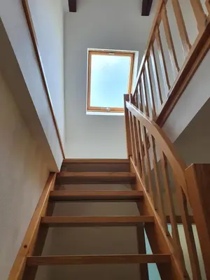 a staircase in a house with a window at Bohinj Star Apartments in Bohinj