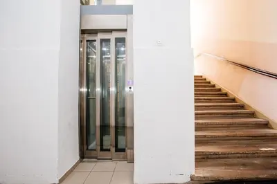 an empty hallway with a door and stairs at Central View Point Apartment in Ljubljana