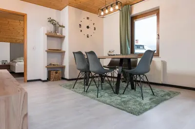 a dining room with a table and chairs at Hiša Rodica in Bohinj