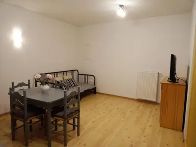 a room with a bed and a table and chairs at Lahova hiša in Ljubno