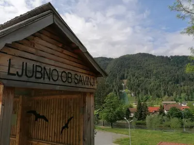 a building with a sign on the side of it at Lahova hiša in Ljubno