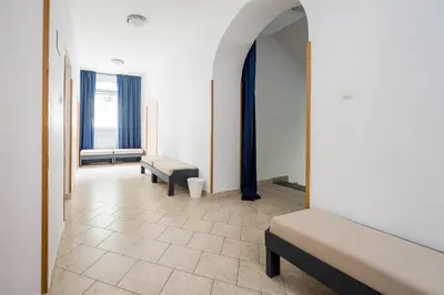 a room with two beds and a hallway with windows at Hostel Kronotop in Triglav National Park in Log pod Mangartom