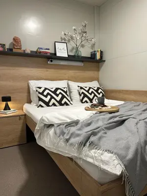 a bedroom with a bed with a tray on it at MAGNOLIA HOUSE by the RIVER in Metlika