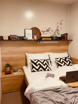 a bedroom with a bed with a laptop on it at MAGNOLIA HOUSE by the RIVER in Metlika