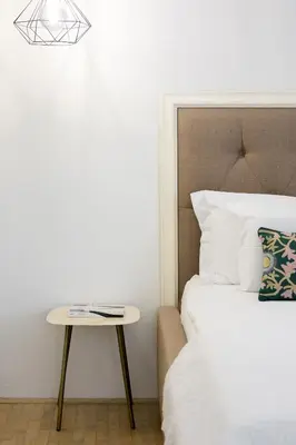 a bedroom with a bed and a side table at City Central in Ljubljana
