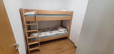a small room with two bunk beds in it at Apartment Podkuze in Mojstrana