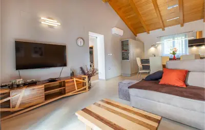 a living room with a large flat screen tv at 3 Bedroom Awesome Home In Divaca in Divača