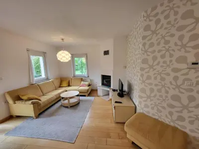 a living room with a couch and a tv at APARTMA GONZO in Bovec
