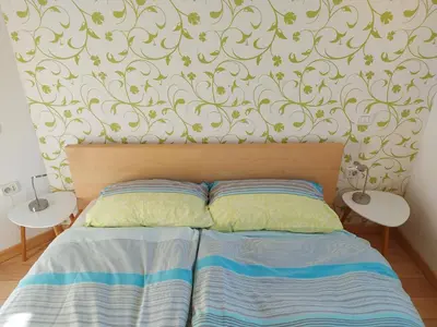 a bedroom with a bed with two night stands next to it at APARTMA GONZO in Bovec
