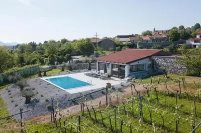 an aerial view of a house with a swimming pool at Villa Rosemary Trieste HerMes arT in Sežana