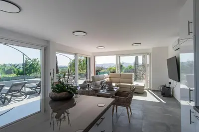 a living room with a couch and a table at Villa Rosemary Trieste HerMes arT in Sežana