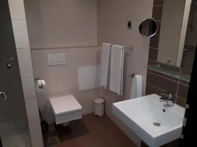 a white bathroom with a sink and a toilet at Nitro Rooms in Ljubljana