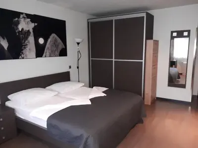 a bedroom with a bed and a large window at Nitro Rooms in Ljubljana