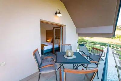 a balcony with a table and chairs and a bedroom at Holiday home in Smarjeske Toplice Kranjska Krain 42904 in Smarjeske Toplice