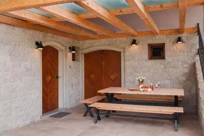a patio with a wooden table and benches at Holiday home in Smarjeske Toplice Kranjska Krain 42904 in Smarjeske Toplice