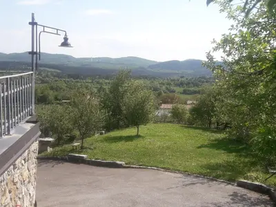 a balcony with a view of a green field at Apartma ODDIH in Dutovlje
