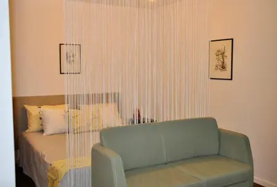 a living room with a couch and a bed at Apartment in the heart of Brda wine region, Darinka Marinič in Dobrovo