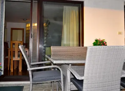 a table and chairs sitting on a porch at Apartment in the heart of Brda wine region, Darinka Marinič in Dobrovo
