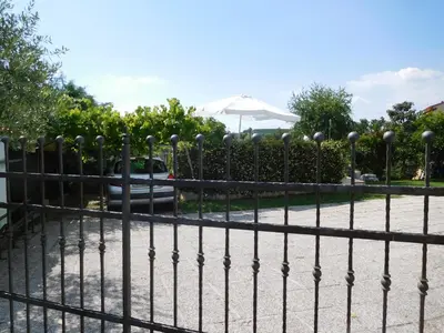 a black fence with spheres on top of it at Apartment in the heart of Brda wine region, Darinka Marinič in Dobrovo