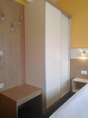 a bedroom with a bed and a desk and a closet at Pri štorklji in Moravske Toplice