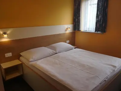 a bed with two pillows in a bedroom with a window at Pri štorklji in Moravske Toplice