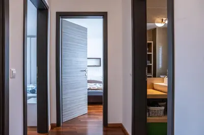 a bathroom with a door leading into a bathroom with a sink at Apartment Panoramic Bovec in Bovec