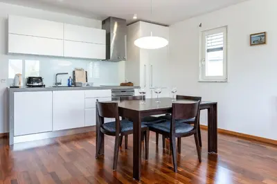 a kitchen with a dining room table and chairs at Apartment Panoramic Bovec in Bovec