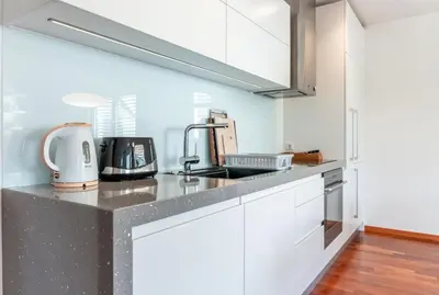 a kitchen with white cabinets and a counter top at Apartment Panoramic Bovec in Bovec