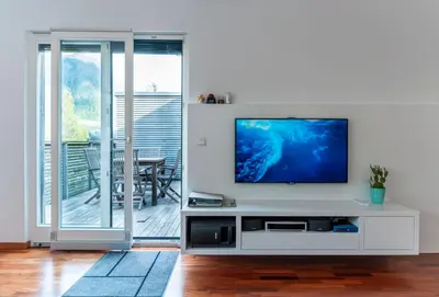 a living room with a television on a white entertainment center at Apartment Panoramic Bovec in Bovec