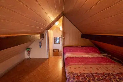 a small bedroom with a bed in a wooden room at Holiday home in Novo Mesto - Dolenjska Bela krajina Unter- Weißkrain 42895 in Novo Mesto