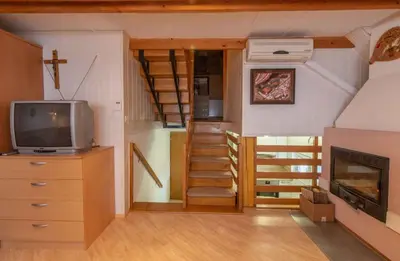 a tiny house with a staircase and a tv at Holiday home in Novo Mesto - Dolenjska Bela krajina Unter- Weißkrain 42895 in Novo Mesto