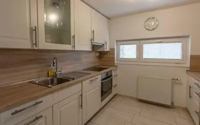 a kitchen with white cabinets and a sink and a window at Holiday home in Novo Mesto - Dolenjska Bela krajina Unter- Weißkrain 42895 in Novo Mesto