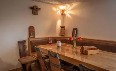 a dining room with a wooden table with two glasses of wine at Holiday home in Novo Mesto - Dolenjska Bela krajina Unter- Weißkrain 42895 in Novo Mesto