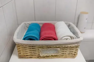 a basket of towels sitting on a counter in a bathroom at Počitniška Hiša Voje in Srednja Vas v Bohinju