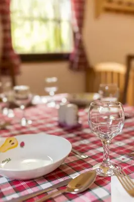 a table with a plate and a wine glass at Počitniška Hiša Voje in Srednja Vas v Bohinju
