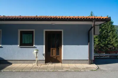 a small house with a door and a parking meter at Guest house Kočanija in Ilirska Bistrica