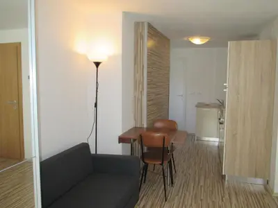a living room with a couch and a table at Studio Brnat in Kobarid